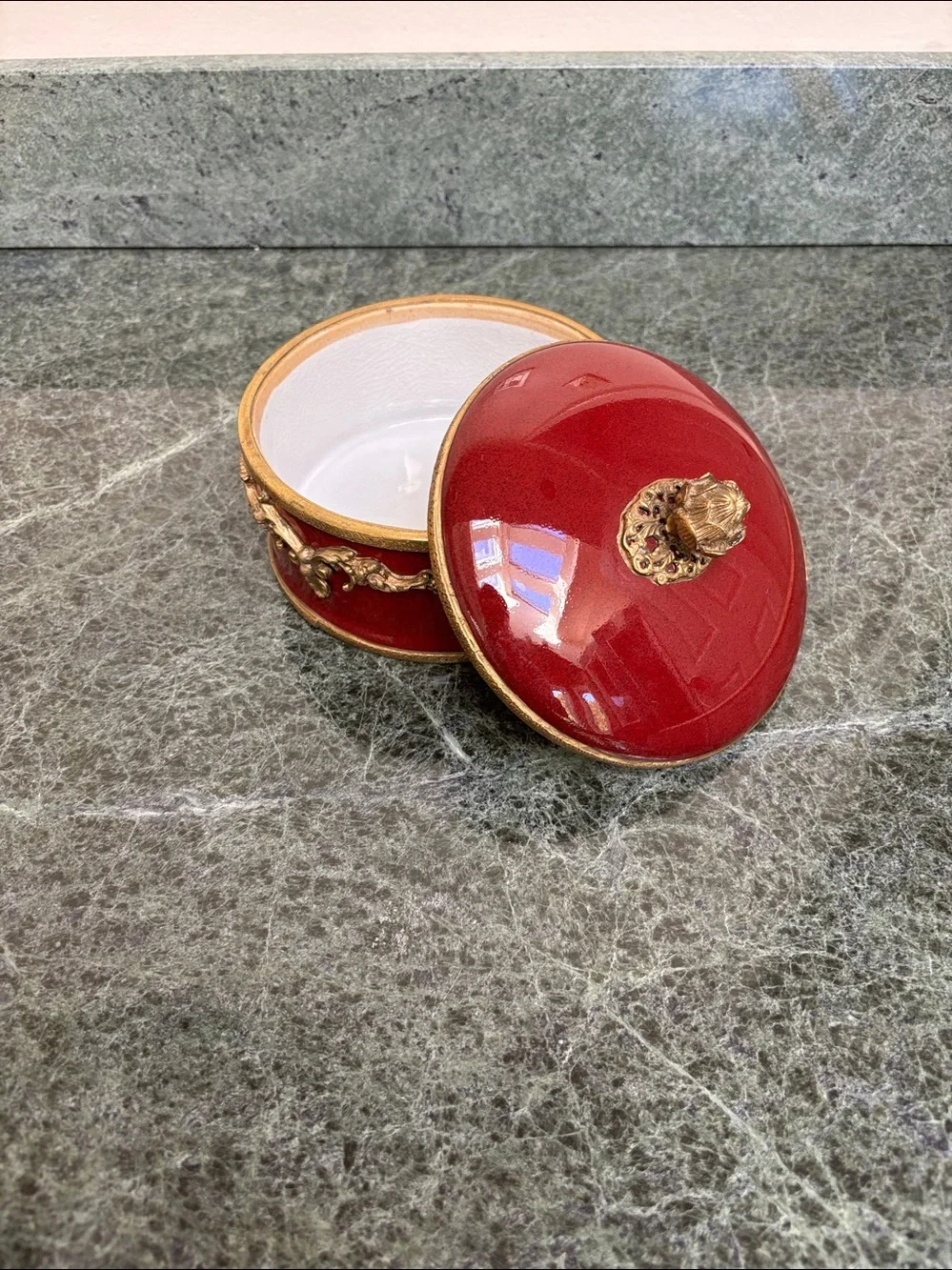 vintage porcelain trinket box with an ornate brass rim